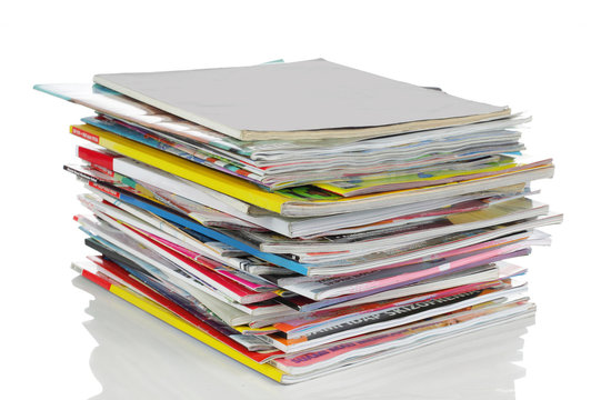 shot of stack of magazines isolated over white