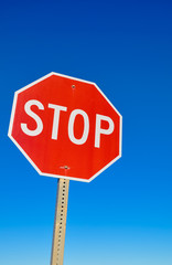 Stop signal against the blue sky