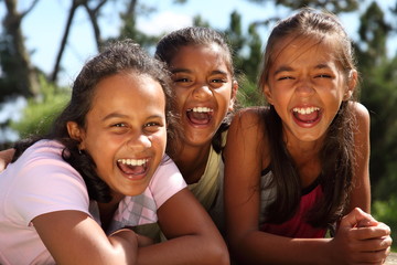 Three school girls enjoying happy moment in the sunshine