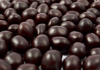 Peanuts or almonds covered with chocolate