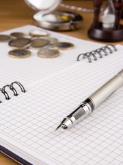 pen and coin on notebook