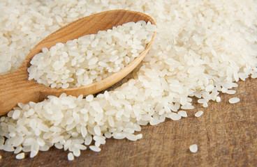 rice grain in wooden spoon