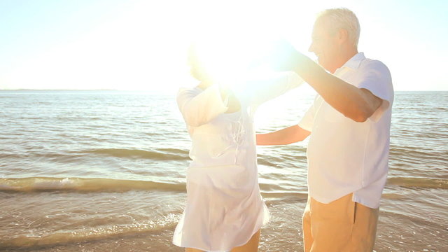 Romantic Seniors Dancing on the Beach