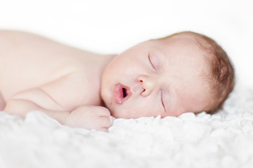 Newborn baby sleeping. Soft focus, shallow DoF.