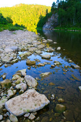 River in the evening. Sunlight reflected on a distant hill
