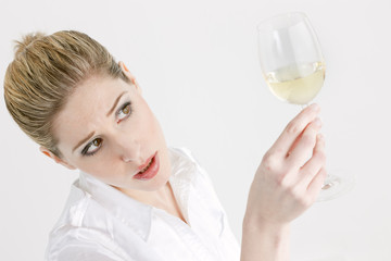 portrait of young woman with a glass of white wine