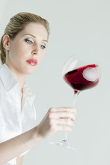 portrait of young woman with a glass of red wine