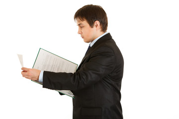 Serious modern businessman holding folder with documents in hand