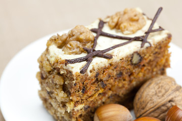 Fototapeta na wymiar Piece of cake with nuts lying on the plate