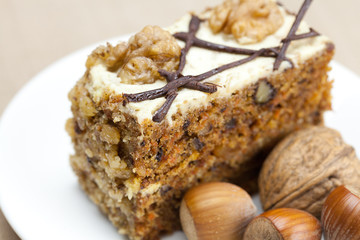 Piece of cake with nuts lying on the plate