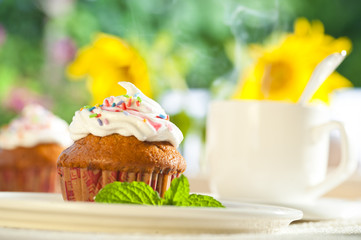 Muffins with cream and a cup of hot coffee