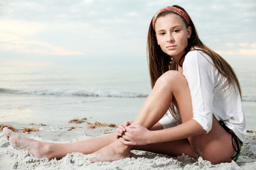 Girl enjoys summer day at the beach.