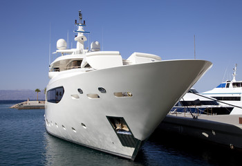 Large luxury yacht moored in marina
