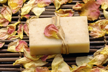 Natural soap with rose petals on mat