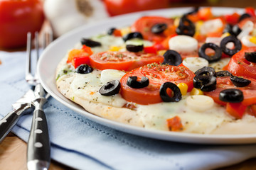 Pizza with mozzarella and fresh tomatoes