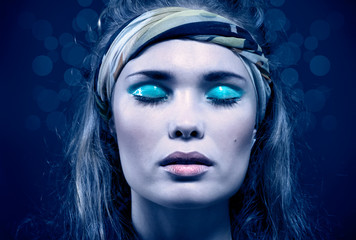 Beautiful young woman with blue make-up