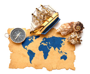compass, rope and model classic boat on map