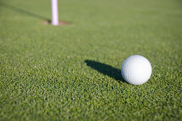 Golf Ball on the Green Near the Pin