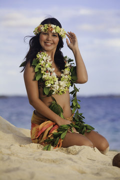 hula dancer sitting on the beach