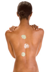 Naklejka premium Back of black woman with multicolored cream patch