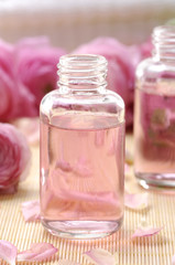 Aromatic massage oil and pink gardenia flowers
