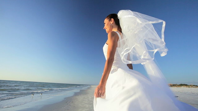Beach Bride With Wedding Dress Blowing in the Breeze
