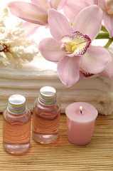spa essentials- (lotion and orchids with white towel)