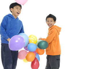 two children with colorful balloons