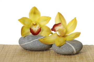 Obraz na płótnie Canvas zen stones with orchid on straw mat