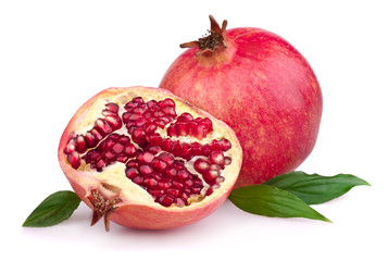 Juicy pomegranate and its half with leaves isolated on white