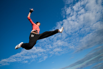 Fototapeta na wymiar sport woman jumping and fly over sky