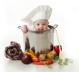 Licking baby sitting in a chef's pot - obrazy, fototapety, plakaty