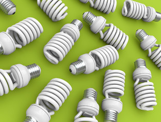 Energy efficient light bulbs on green plane; 3D render