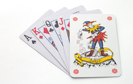 Gambling with playing cards over a white background .