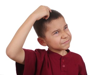 Boy scratching head confused, eight years old