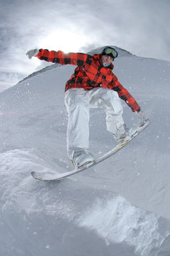 Jumping freestyle snowboarder
