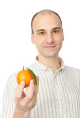 man holding tangerine