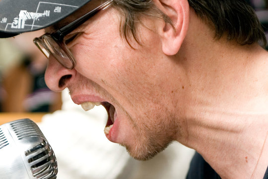 Man singing in front of a microphone