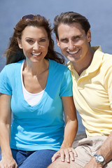 Obraz premium Successful Happy Middle Aged Man & Woman Couple Sitting Outside