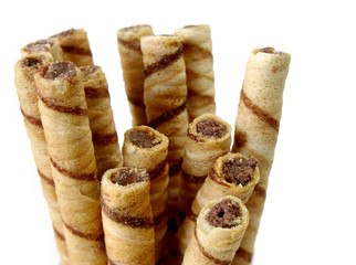 Rolled waffles with hazelnut on the white background