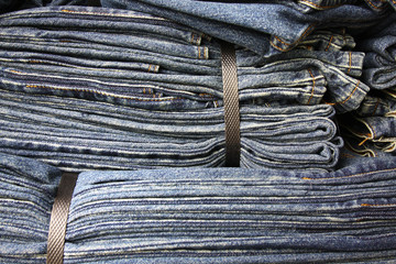 Bunch of binded blue jeans layer together.