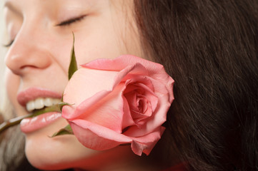 Obraz na płótnie Canvas The woman with a rose closeup