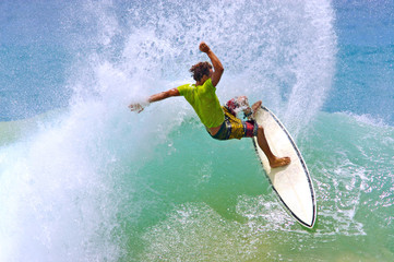 surfer hitting wave lip creates a water curtain spray - obrazy, fototapety, plakaty