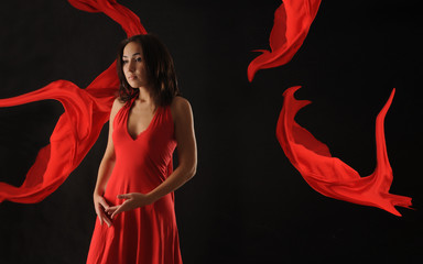 Beautiful asian girl  in red dress over black background