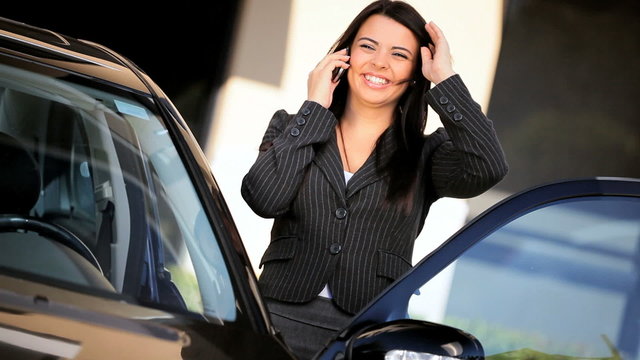 Female Executive with Cell Phone Leaving by Car