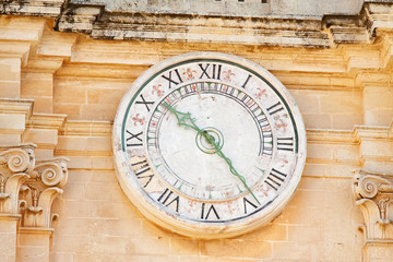 Fototapeta na wymiar Clock on Cathedral Tower at Mdina