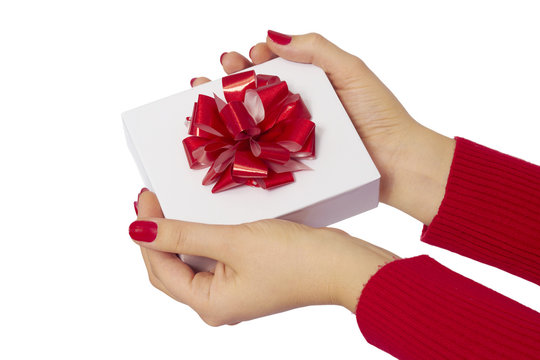 Gift with red bow placed on female hand