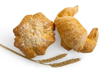 Croissant and bread roll with stems of wheat