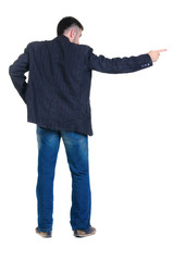 young man pointing at wall. rear view.