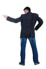 young man pointing at wall. rear view.